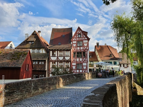 Scenic cityscape with historic half-timbered houses near the historic bridge over the Blau river in Ulm, Germany.