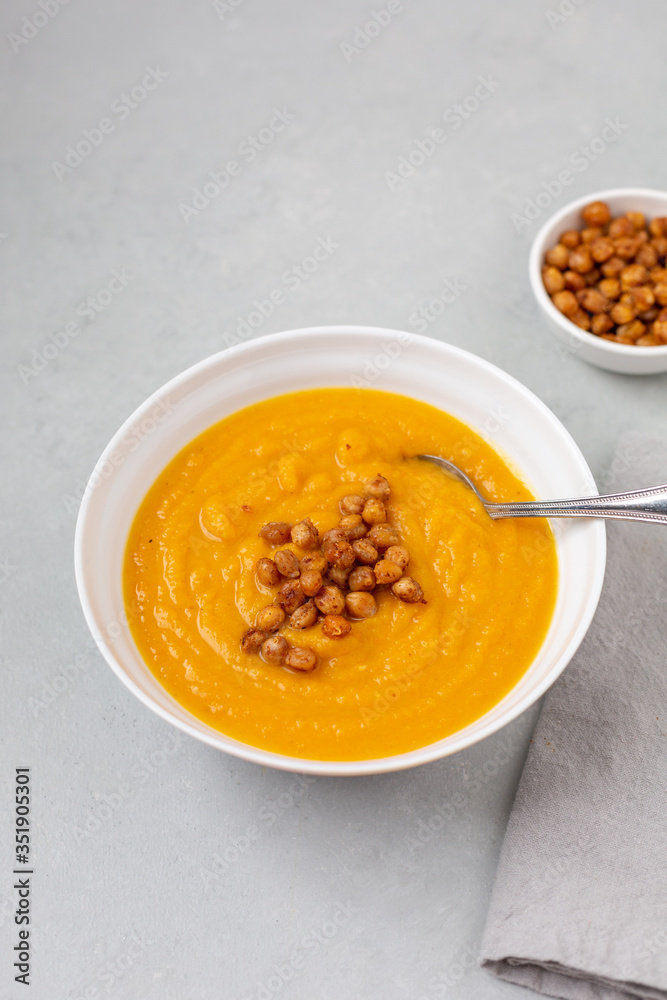 Homemade Butternut Squash Soup in White Bowl on Gray background; Roasted Chickpea Garnish