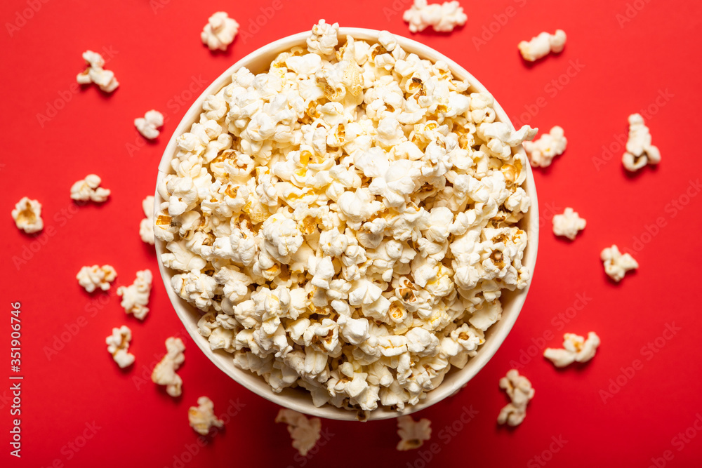 Delicious popcorn on a red background. View from above Delicious popcorn on a red background. View from above