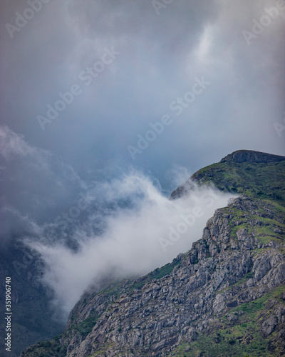 clouds hitting between the mountain beautiful landscape