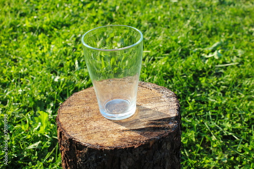 The glass is on the stump