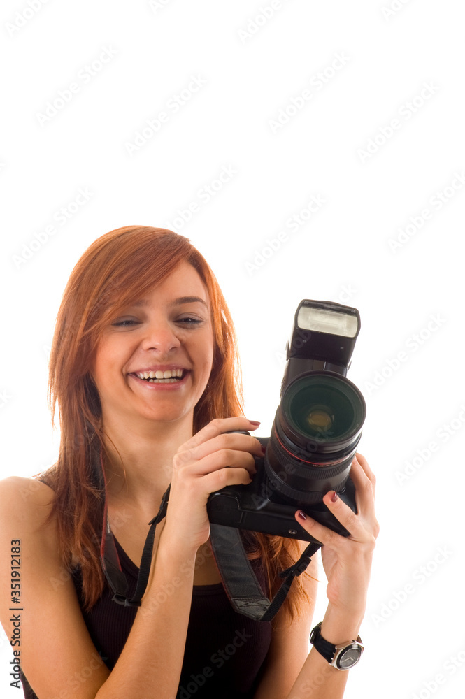 Smiling young girl holding camera, isolated on white background Smiling young girl holding camera, isolated on white background