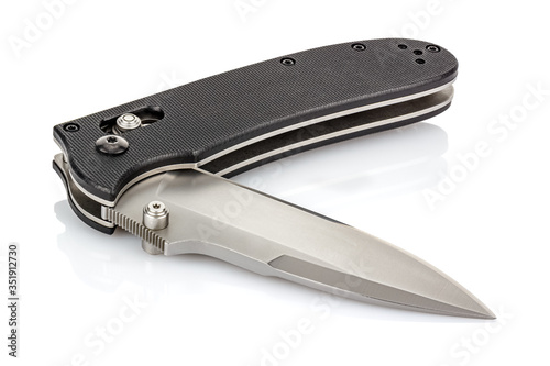 Lying open folding pocket knife with satin blade and black composite plastic cover plates on steel handle isolated on white background with reflection on glossy surface. Pocket knife close-up image