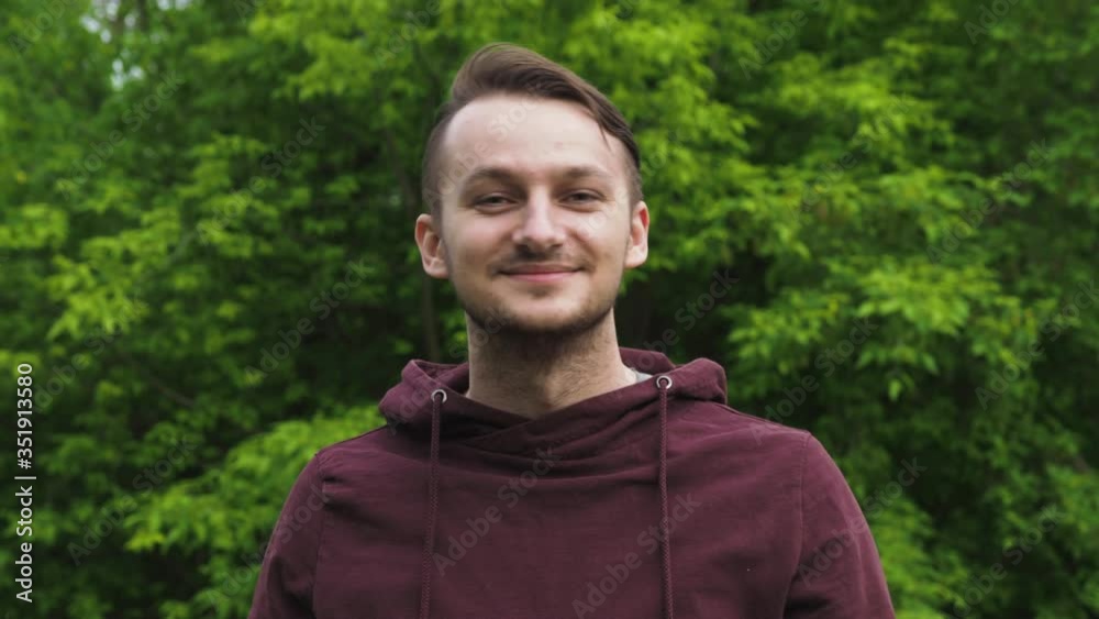 Happy young guy takes off his medical mask and breathes fresh air in nature. Rejoices over the end of the coronavirus pandemic and isolation. Happy young guy takes off his medical mask and breathes fresh air in nature. Rejoices over the end of the coronavirus pandemic and isolation.