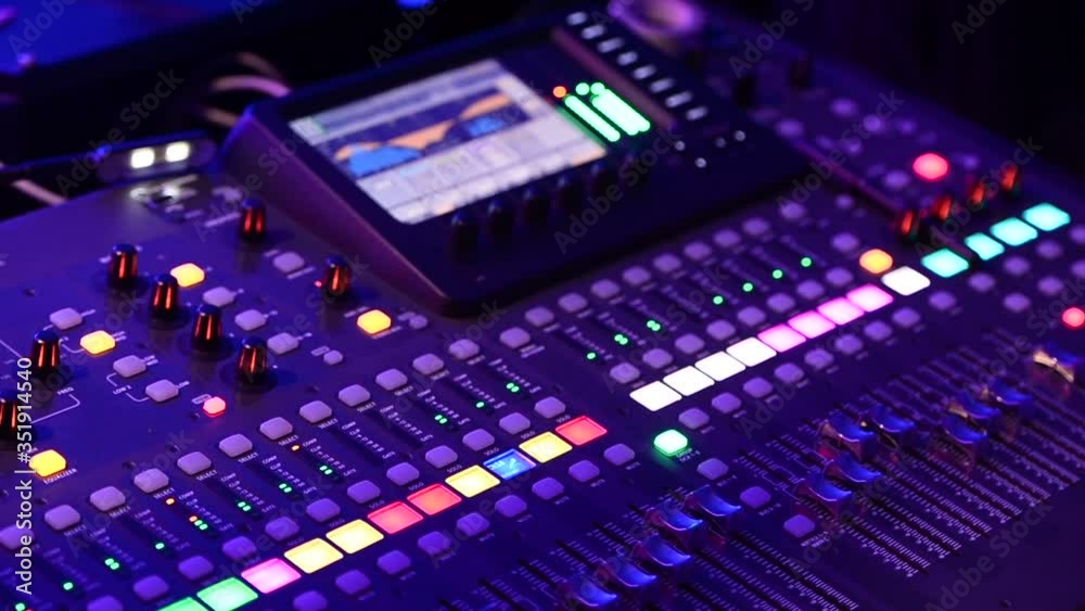 mixer console of the sound engineer near the stage to the performance of a musical group, close-up