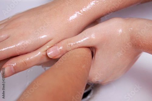 Good hygiene - a great habit - cleaning the hands of two young women