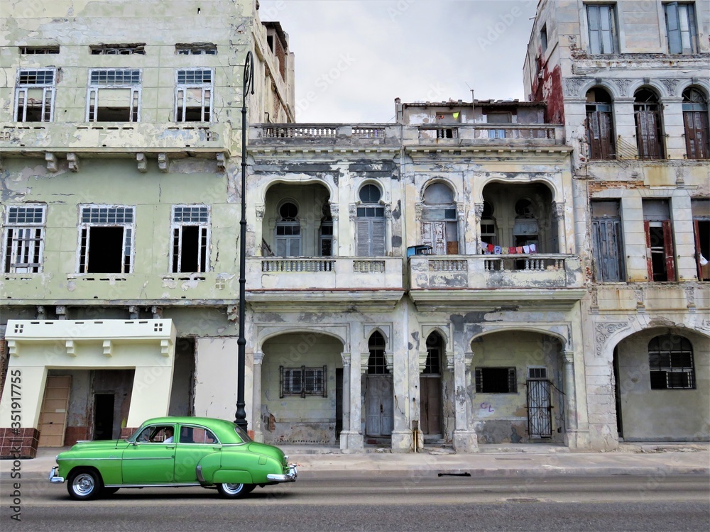 Vintage Cuban car driving through the streets of Havana 