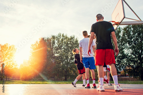 Group Of Young Friends Playing Basketball Match