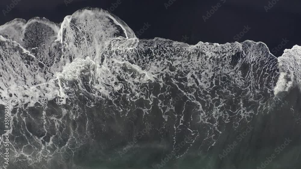 Aerial top view beautiful nature of volcanic black sand beach and giant waves Aerial top view beautiful nature of volcanic black sand beach and giant waves