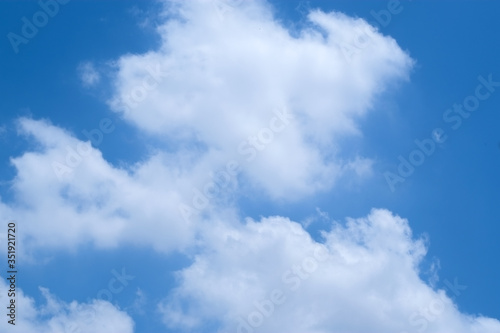 Group of white fluffy clouds and blue sky