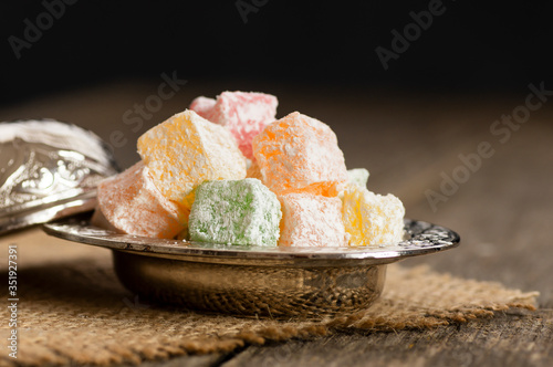 Turkish delight in hollowware , traditional fruity flavored turkish sweet food photo