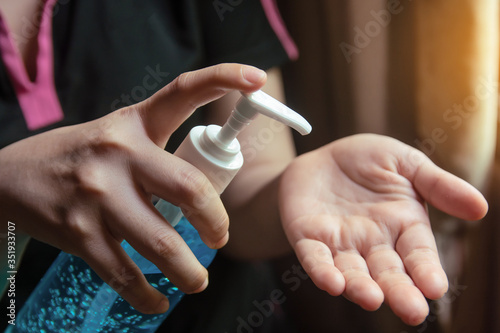 Woman using alcohol gel for cleaning hands prevention of coronavirus virus outbreak.