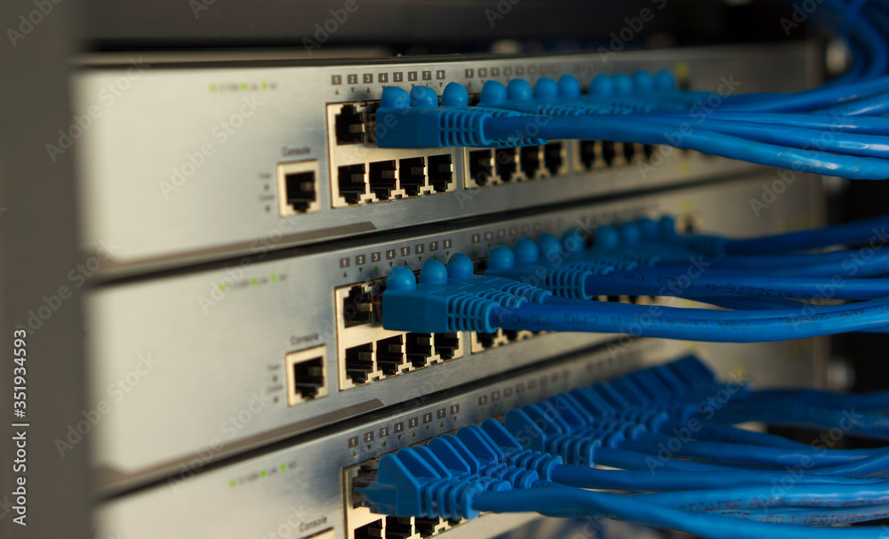 Closed data center Internet provider. Cable and switch connections. High speed internet network. Computer network. Ethernet telecommunication cables connected to an Internet switch. LAN Closed data center Internet provider. Cable and switch connections. High speed internet network. Computer network. Ethernet telecommunication cables connected to an Internet switch. LAN