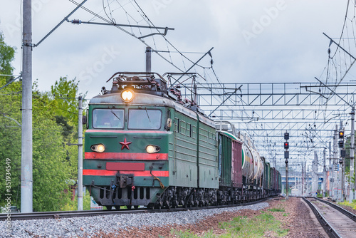 Freight train moves at evening summer time.