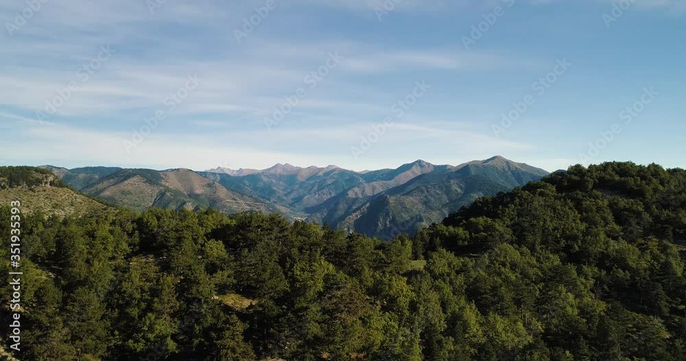 Stunning mountain landscape revealed from behind forest on top of mountain Stunning mountain landscape revealed from behind forest on top of mountain