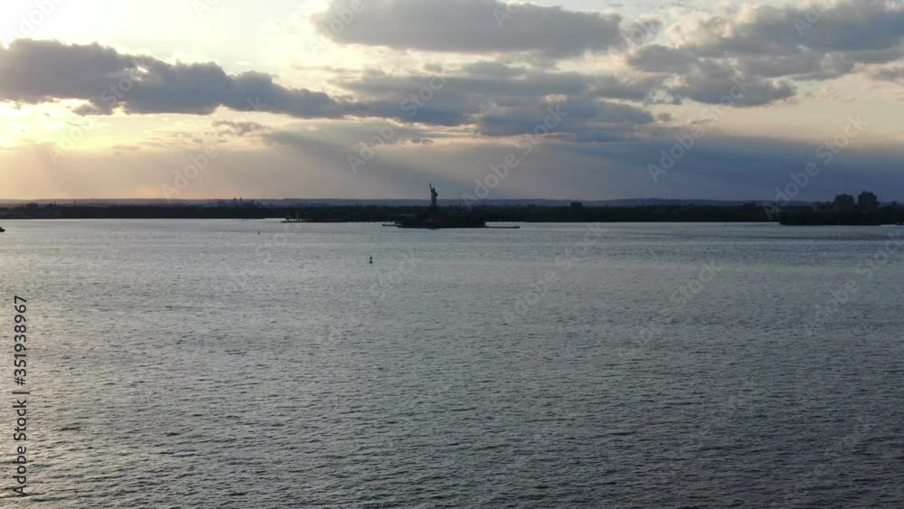Vision of the Statue of Liberty in the distance at sunset Vision of the Statue of Liberty in the distance at sunset