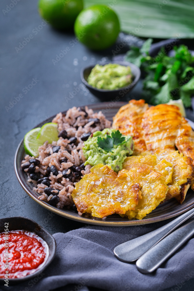 Rice with black beans, fried chicken breast and tostones, plantains Rice with black beans, fried chicken breast and tostones, plantains