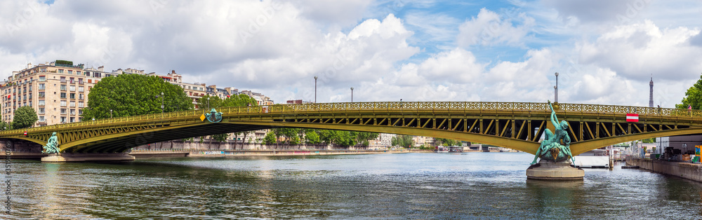 Fototapeta premium Paris, France: Panoramic view of Pont Mirabeau bridge with eiffel tower in background.