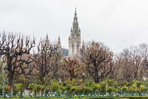 Building of the Vienna City Hall (Rathaus) in a rainy day, the seat of local government of Vienna, located on Rathausplatz in the Innere Stadt district photo