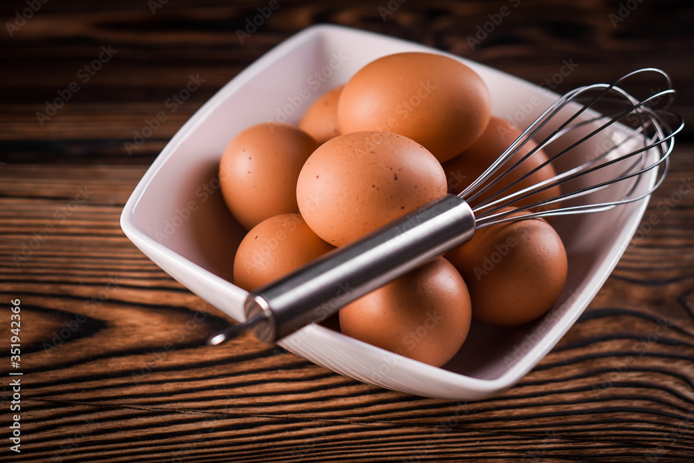 Detail close-up of chicken eggs on the old brown wooden background. Detail close-up of chicken eggs on the old brown wooden background.