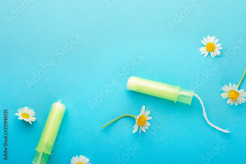 Feminine hygiene Chamomile flowers composition on blue background