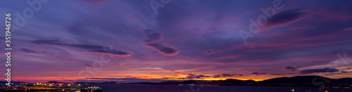 Panoramic sunset sky full of clouds with warm tones