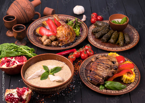 Hospitable Georgian cuisine. Set with delicious food on ethnic plates