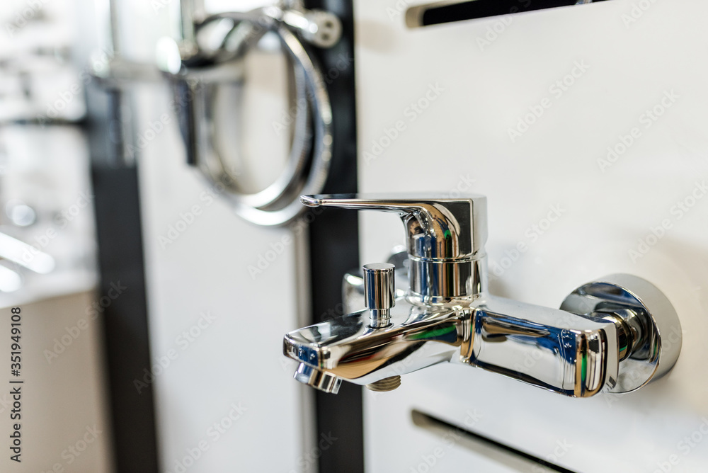Water mixer tab in a bathroom interior shop. Water mixer tab in a bathroom interior shop.