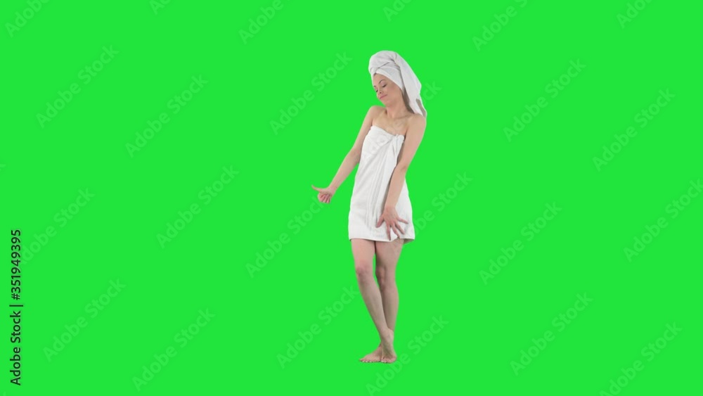 Unplanned journey concept. Young unprepared woman in bath towel hitchhiking with thumb up. Full body length keyed out on green screen background. Unplanned journey concept. Young unprepared woman in bath towel hitchhiking with thumb up. Full body length keyed out on green screen background.