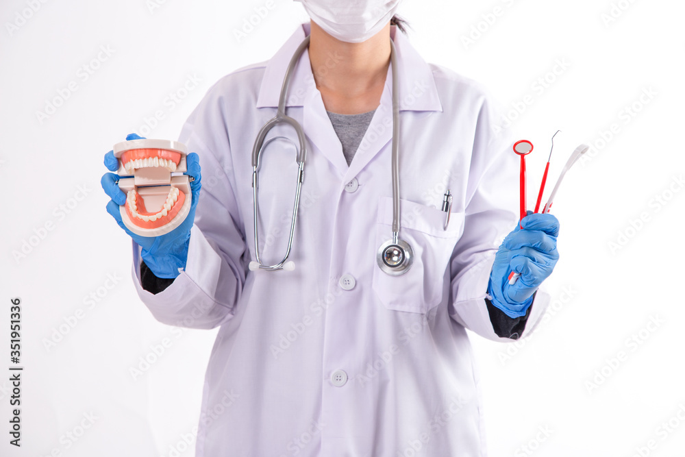 Woman dentist practicing work on tooth model. Care for healthy teeth.
Woman dentist practicing work on tooth model. Care for healthy teeth.