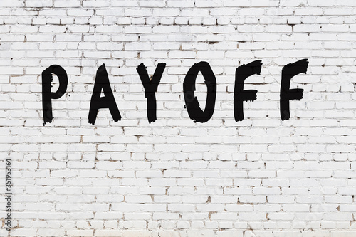 White wall with black paint inscription payoff on it