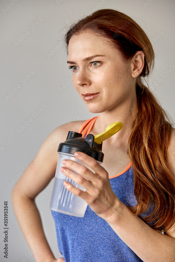 In the hands of the girl shaker with water. Playing sports. In the hands of the girl shaker with water. Playing sports.