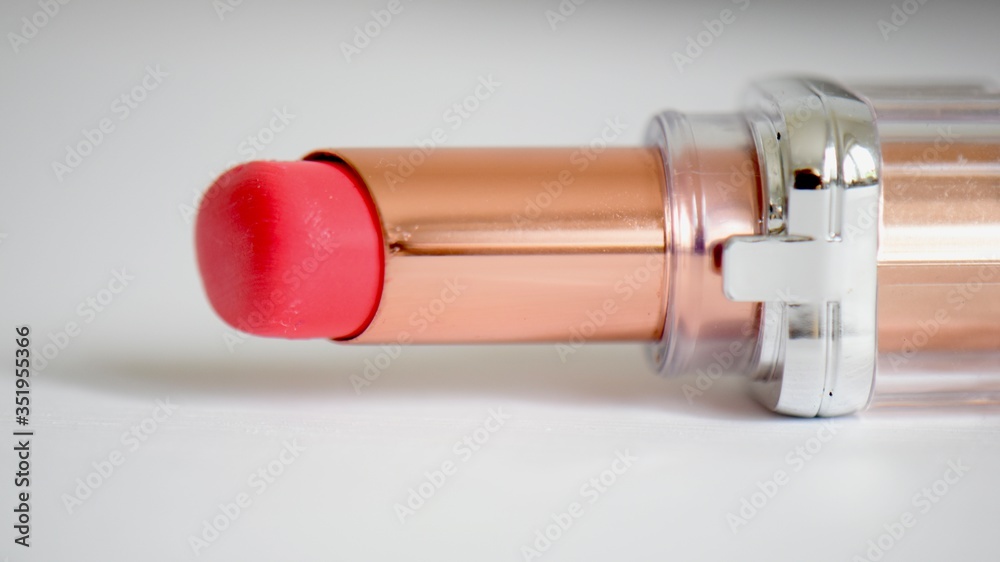 close up of summer coloured lipstick with white copy space 