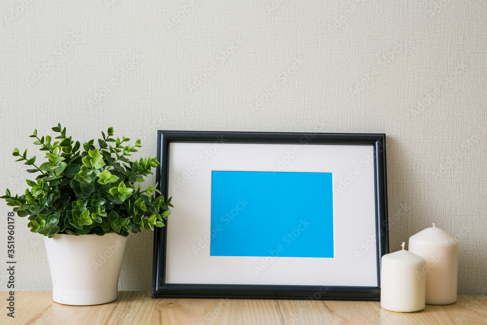 Mockup of a black photo frame with Passepartout. The light interior in the Scandinavian style Mockup of a black photo frame with Passepartout. The light interior in the Scandinavian style