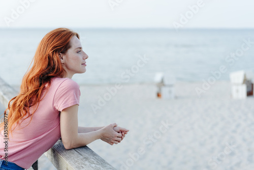 Young redhead woman enjoying a day at the beach