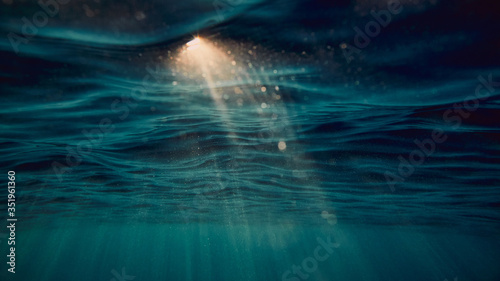 surface of the sea from underwater and sun flare photo