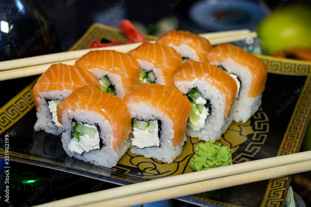 Sushi with red fish. Sushi plate, wasabi and sushi sticks Sushi with red fish. Sushi plate, wasabi and sushi sticks