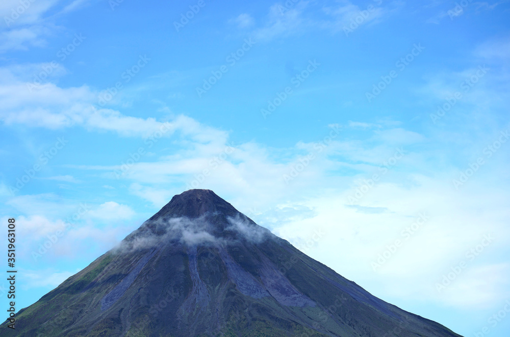 Arenal vulcano summit with mist and clouds