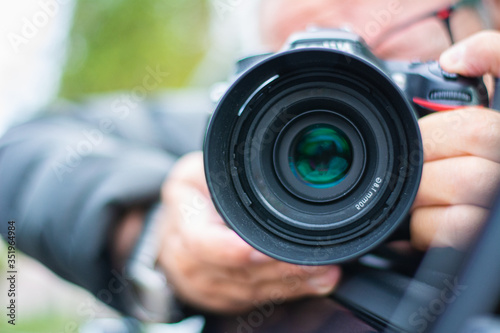 Professional photographer shooting a selfie with a DSLR camera