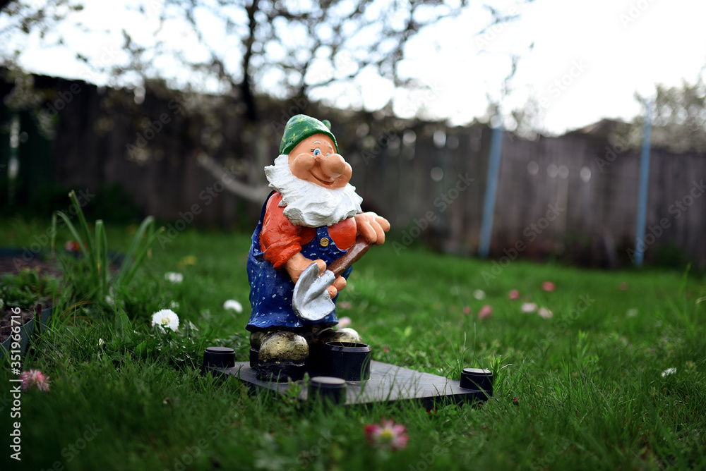 A little nice gnome in spring garden A little nice gnome in spring garden
