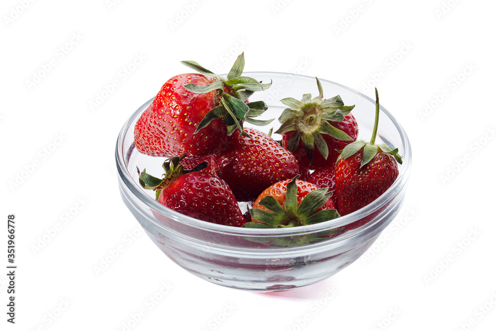 fresh red strawberries in a transparent salad bowl on a white background fresh red strawberries in a transparent salad bowl on a white background