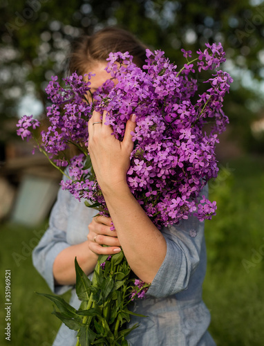 A bouquet of lilac wild flowers in your hands.