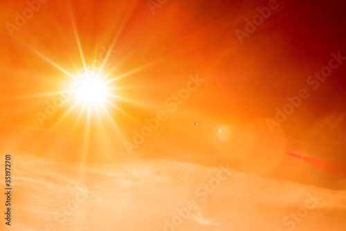 Murais de parede Orange sky with bright sun symbolizing climate change and global warming