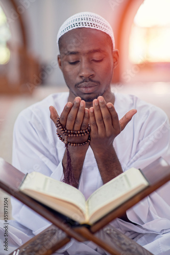 Photography Religious black muslim man praying inside the mosque