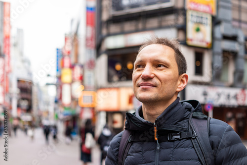 Photography Tokyo, Japan Shibuya ward with closeup of happy man tourist in famous Koen dori