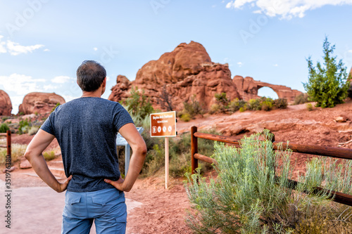 Obraz na plátně Canyons at Arches National Park with Skyline Arch in background and back of youn