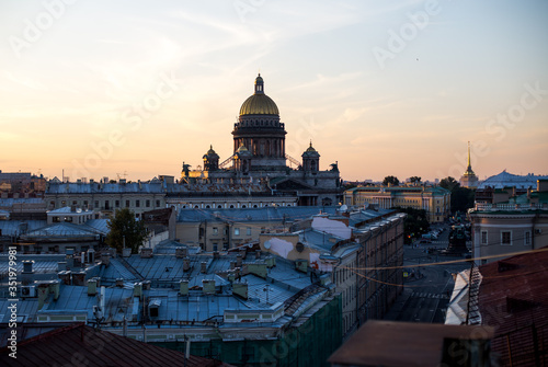 Sunset view at the Isaak Cathedral from the roof of Saint-petersburg city. Ancient roof of the city. Old historical city. Amazing sunset at the top of the city. © Liudmila Puchinskaia