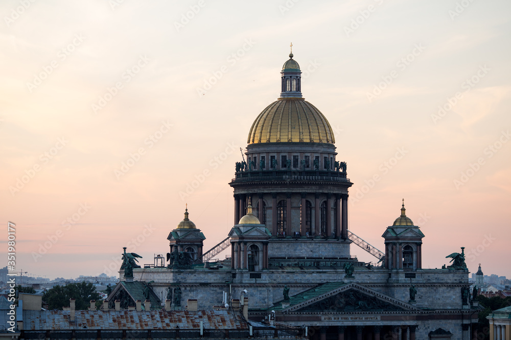 Sunset view at the Isaak Cathedral from the roof of Saint-petersburg city. Ancient roof of the city. Old historical city. Amazing sunset at the top of the city.