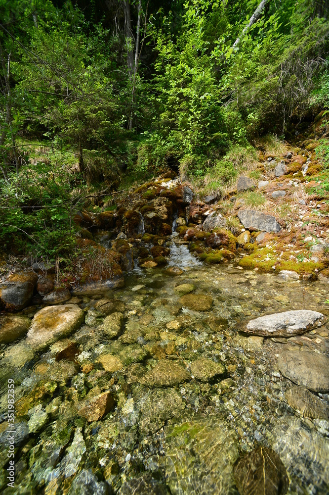 crystal clear water with a small waterfall in nature crystal clear water with a small waterfall in nature
