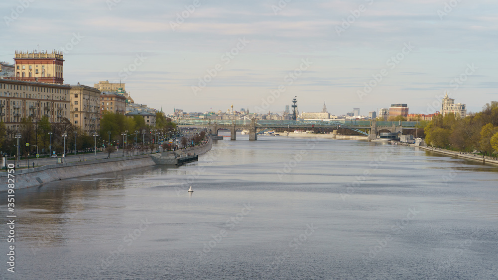 Naklejka premium Moskva River embankment, Gorky Park is popular for walking. Coronavirus pandemic. Rest for nature. Peter the Great Statue, Kremlin, Andreevsky (Pushkinsky) pedestrian bridge in distance